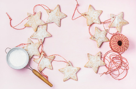 Christmas gingerbread star shaped cookies with sugar powder in sieve