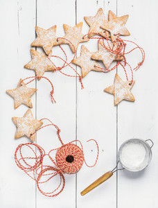 Christmas gingerbread star shaped cookies with sugar powder red rope
