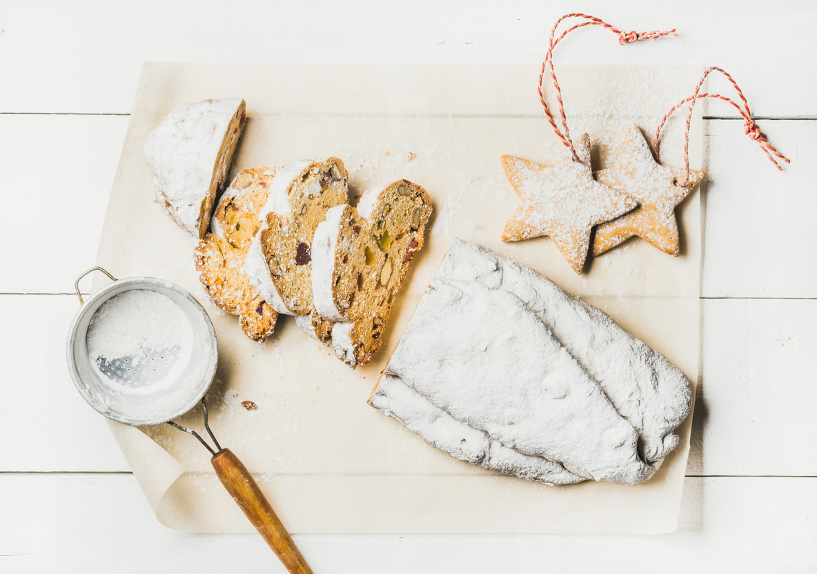 Traditional German Christmas cake Stollen cut in pieces, white background