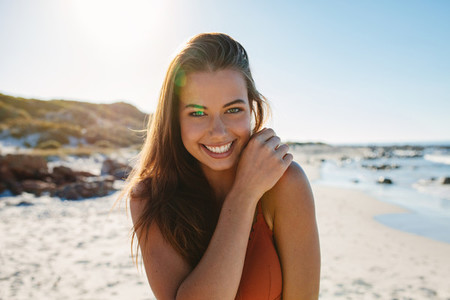 Beautiful smiling bikini woman at sea shore