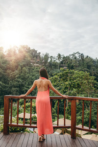 Woman standing by a railing at luxury resort