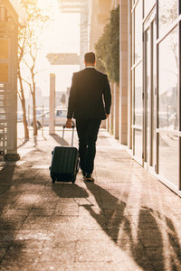 Business traveler with suitcase outside airport