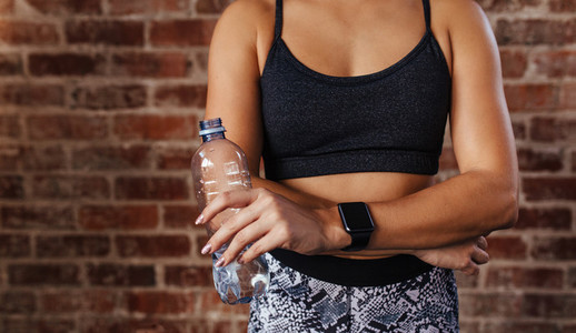 Woman in sportswear holding a water bottle