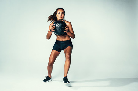 Fit young woman exercising with medicine ball