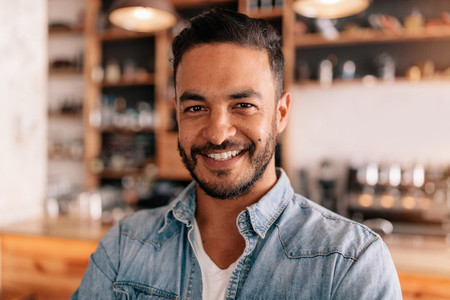 Smiling young man in a coffee shop