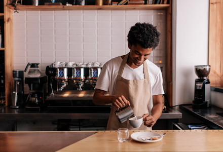 Professional barista preparing coffee on counter