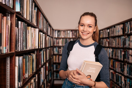Young female college student in library