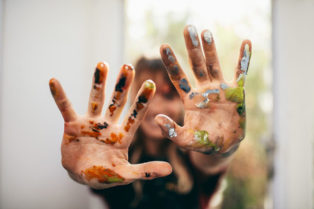 Artist showing her messy hands