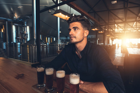 Man tasting different types of beer at the brewery