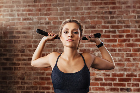 Young woman doing neck exercises using a band