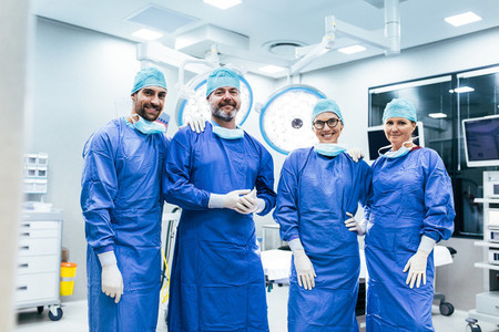 Successful team of surgeon standing in operating room