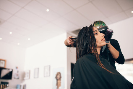 Young woman hairdressing at a salon