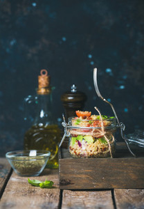 Homemade jar quinoa salad with vegetables and fresh basil