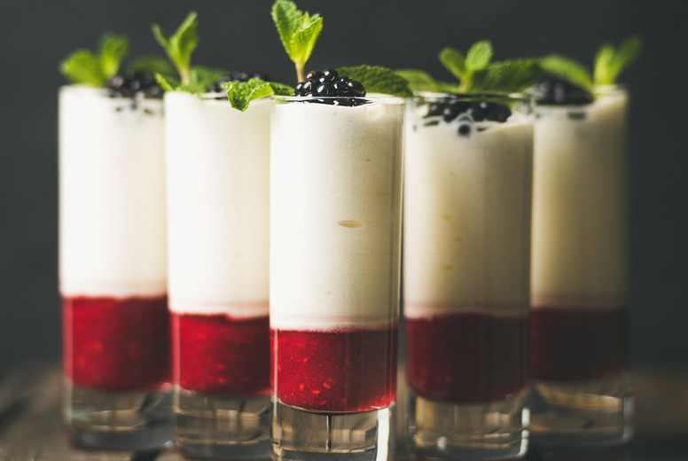 Dessert in glass with blackberries and mint, copy space