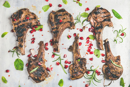 Meat barbecue dinner with grilled lamb ribs and pomegranate herbs