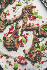 Lamb meat ribs barbecue with pomegranate seeds and herbs