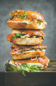 Heap of Bagels with salmon eggs vegetables capers and cream cheese