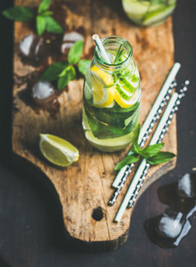 Citrus fruit and herbs infused sassi water on wooden board