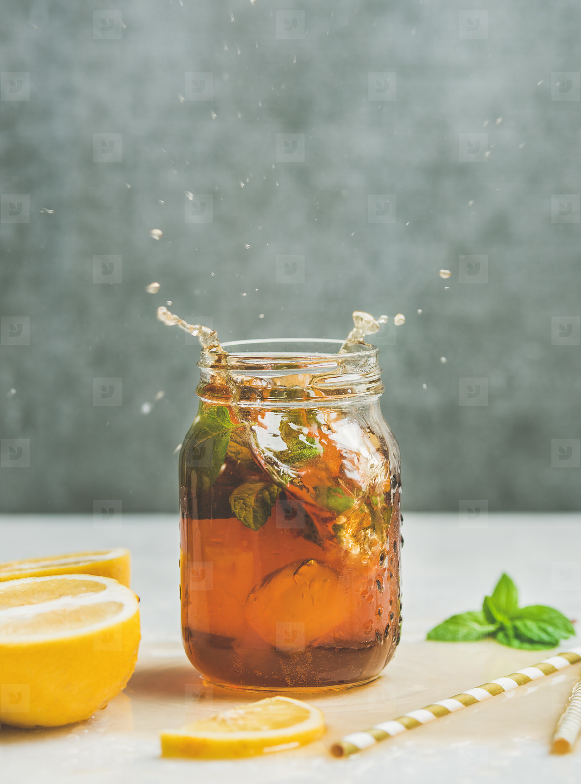 Summer Iced tea with lemon and herbs  copy space