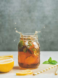 Summer Iced tea with lemon and herbs copy space