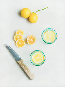 Morning detox lemon water in glasses  marble background  top view