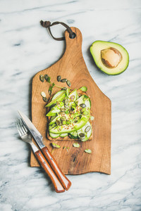Healthy green veggie breakfast concept with sandwich on board