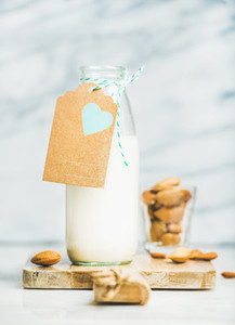 Fresh vegan dairy free almond milk in bottle with craft label
