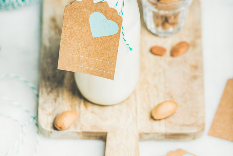 Fresh vegetarian dairy-free almond milk with copy space label