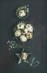 Quail eggs in metal molds and dried flowers for Easter