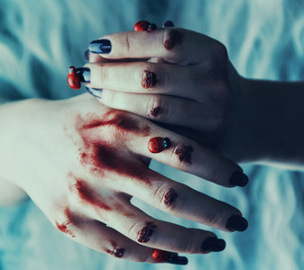 Hands with blood and ladybugs