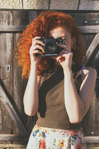 Young redhead photographer