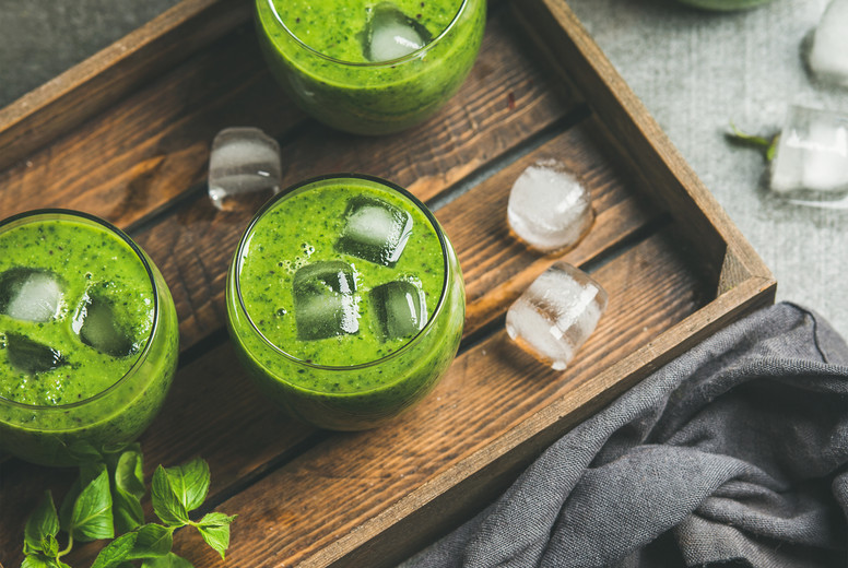 Fresh green smoothie with ice cubes, mint and lime