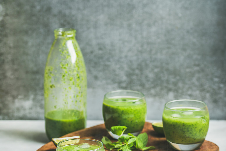 Healthy fresh smoothie in bottle and glasses, copy space