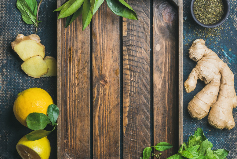 Ingredients for making natural drink with wooden tray in center