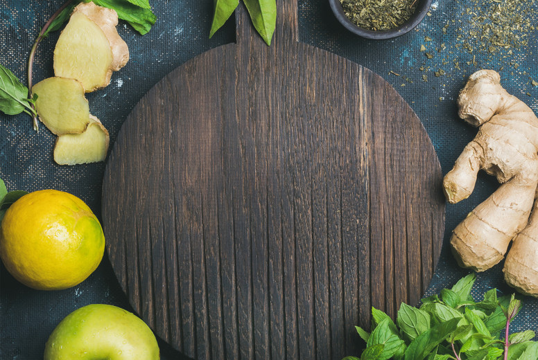 Ingredients for making natural drink, wooden round board in center