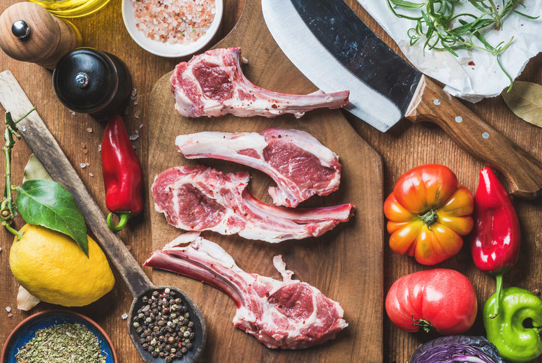 Raw uncooked lamb meat chops, rice, oil, spices and vegetables