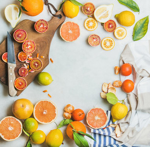 Citrus fruits slices over grey marble background top view