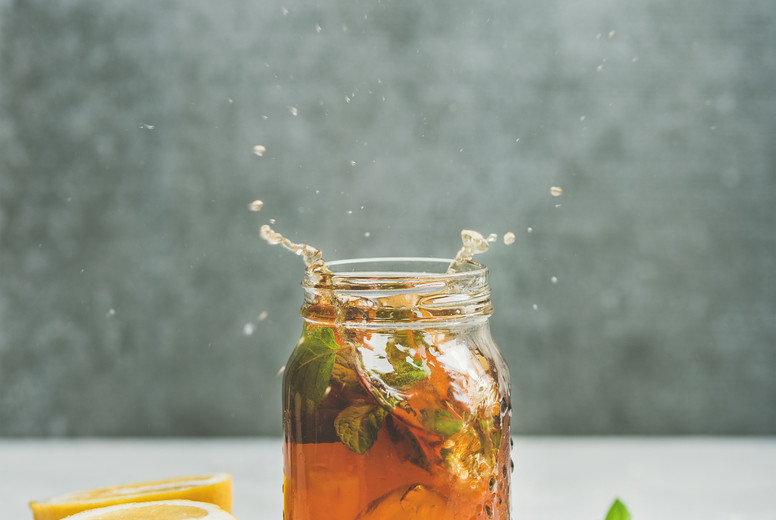 Summer Iced tea with lemon and herbs, copy space