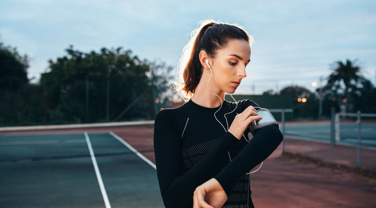 Sporty woman getting ready for fitness outdoor