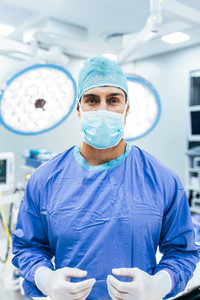 Surgeon wearing surgical gloves and scrubs in operation theater