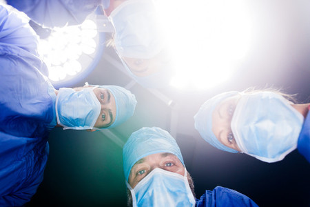 Surgeons performing dental surgery