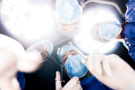 Surgeons operating under surgery lights