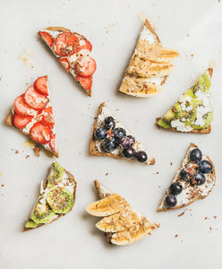 Healthy breakfast toasts with fruit  nuts  seed and cream cheese