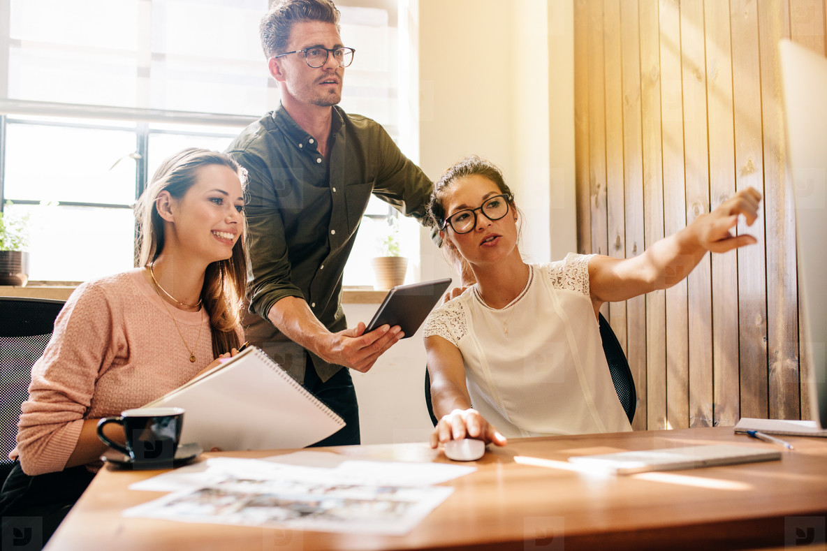 Creative business team working together on computer