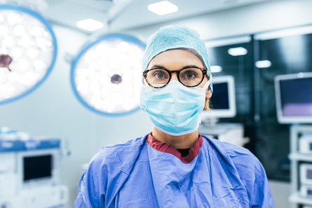Female surgeon wearing surgical mask and scrubs