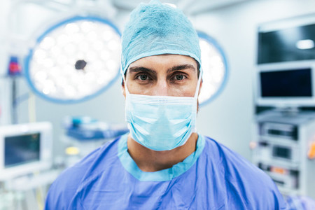 Surgeon wearing surgical mask and scrubs in operation theater