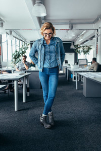 Businesswoman standing in office and looking down