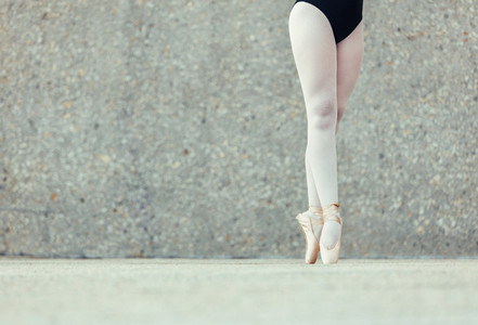 Close up of legs of ballet dancer standing on toes