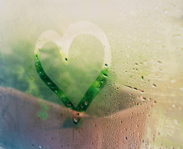 A heart drawing in a wet window