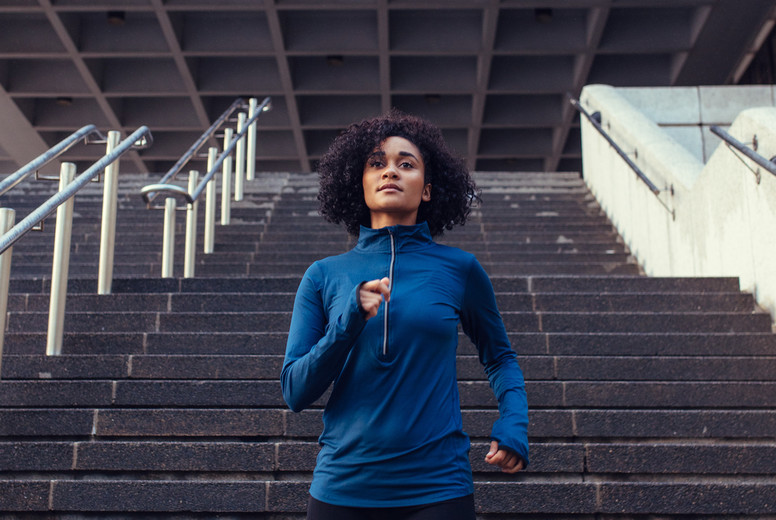 Woman running down the stairs of a building